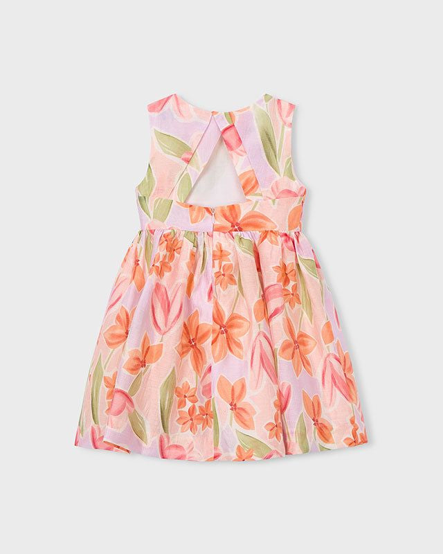 Dettaglio dell'abito cerimonia bambina con fiocco rosa e stampa floreale