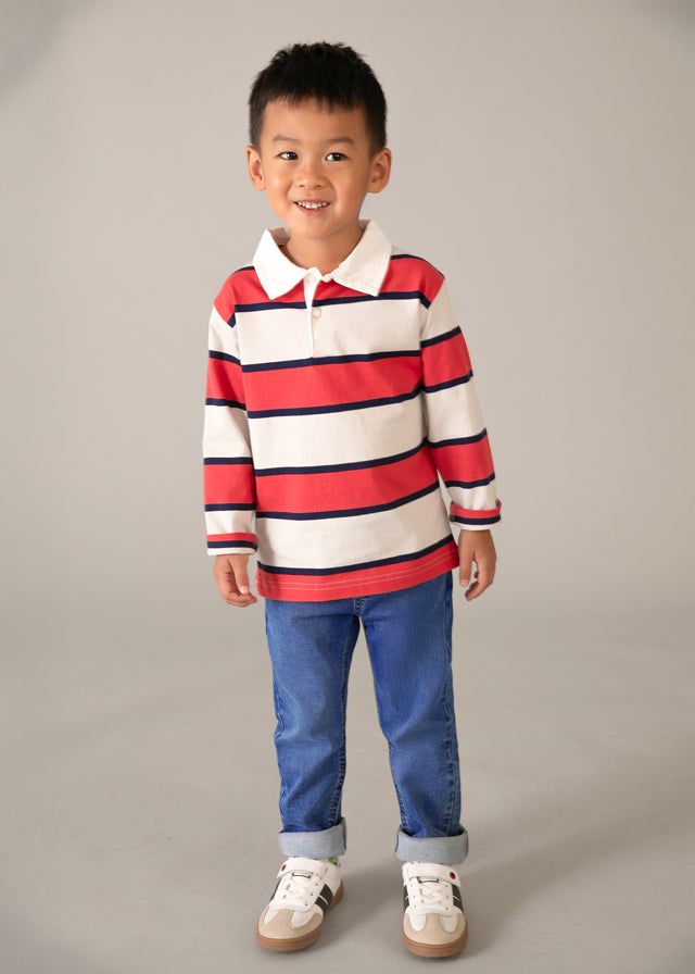 Bambino con jeans e maglia a righe rosse e bianche
